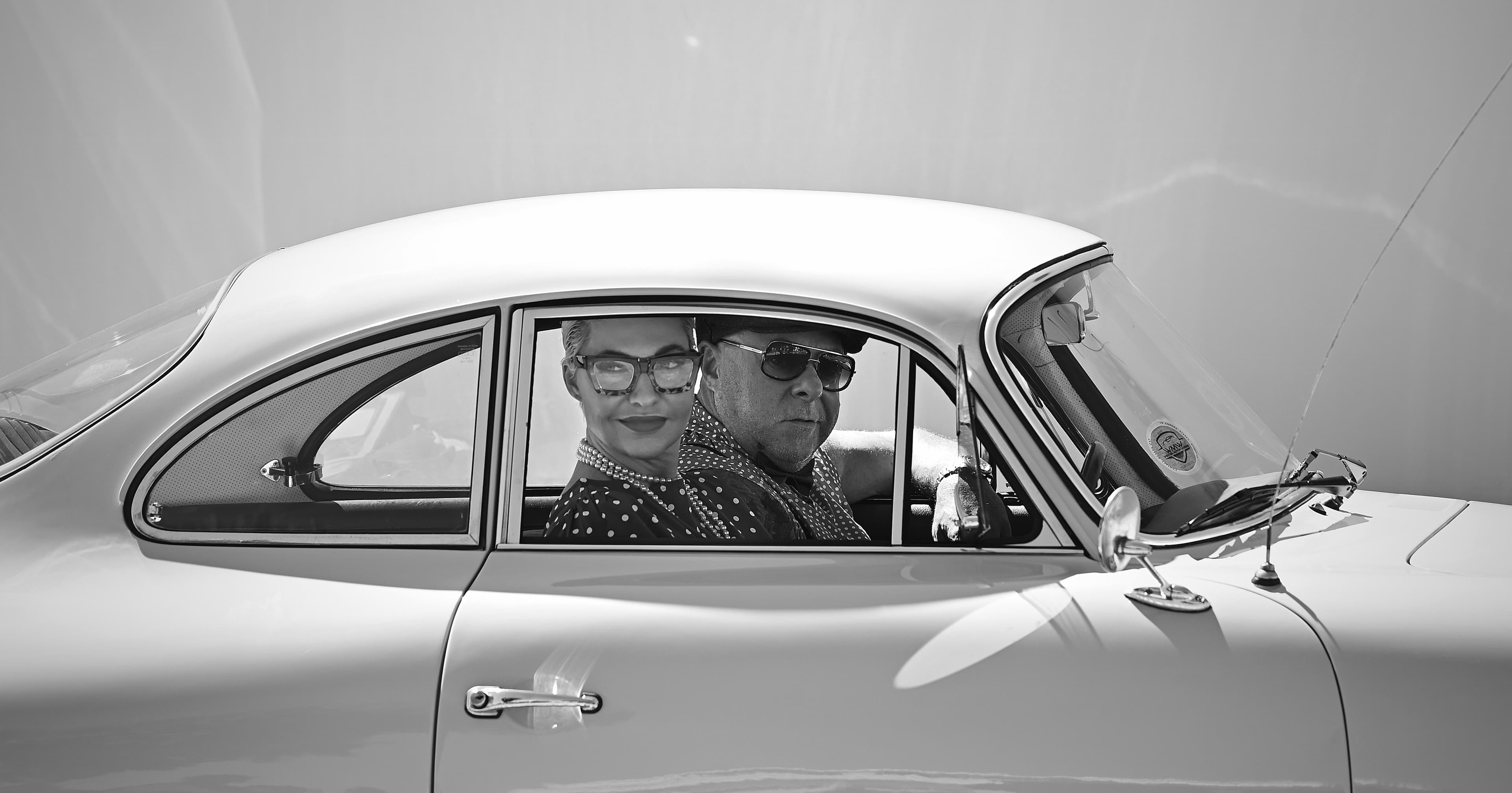 A driver and passenger seated in a classic car during The Cape 1000.