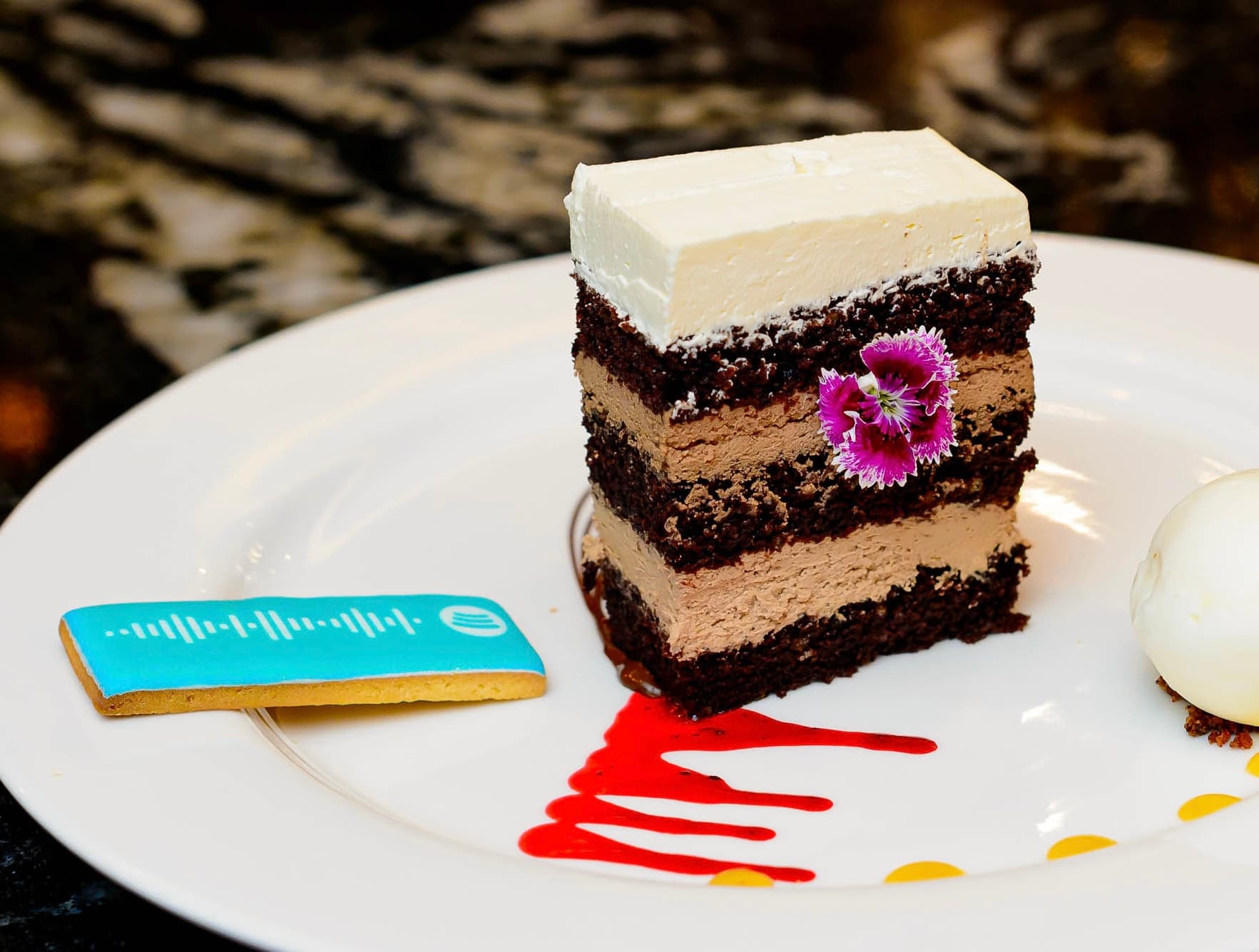 A Spotify biscuit presented alongside a plated dessert.