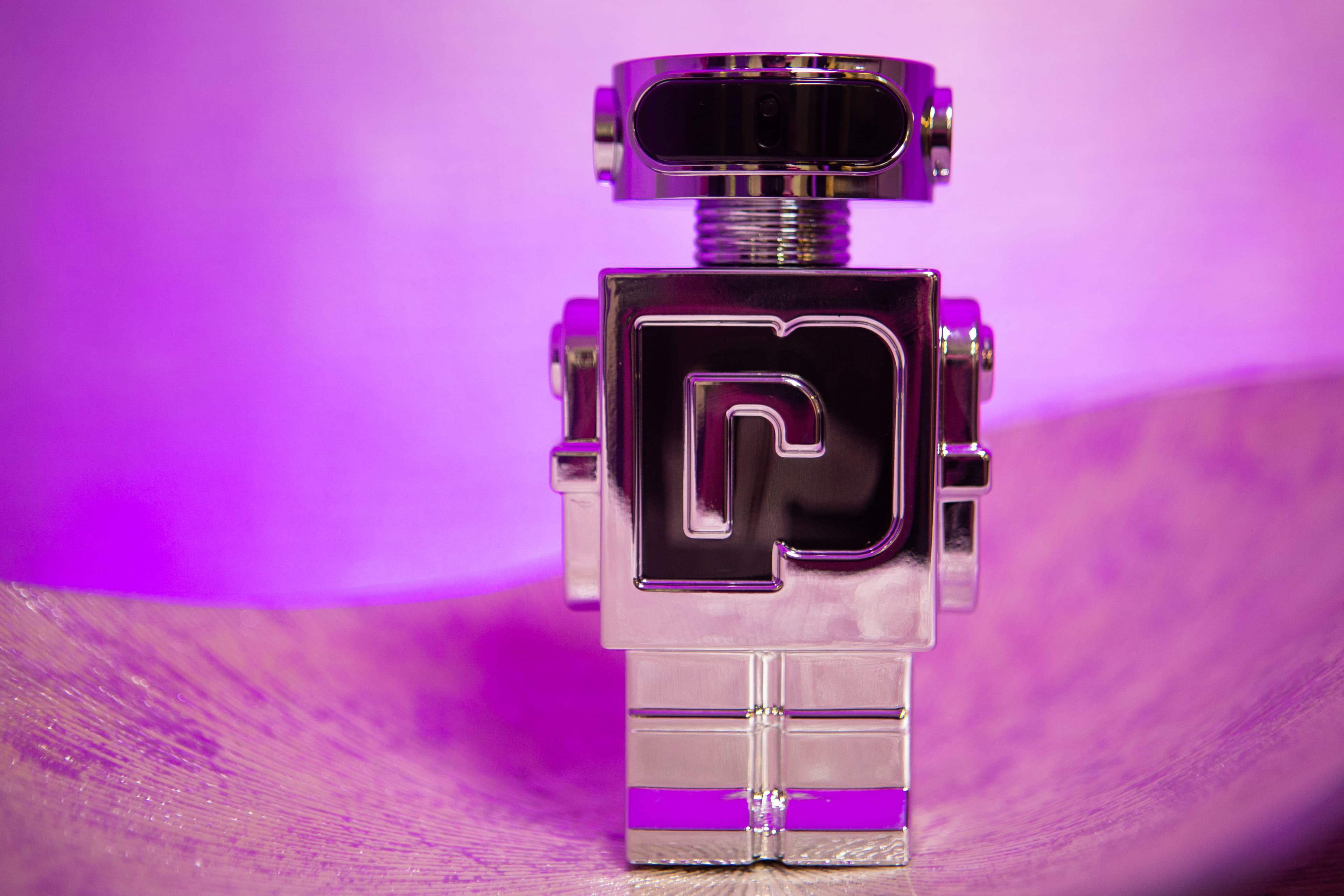 Paco Rabanne Phantom fragrance photographed in a purple studio setting.