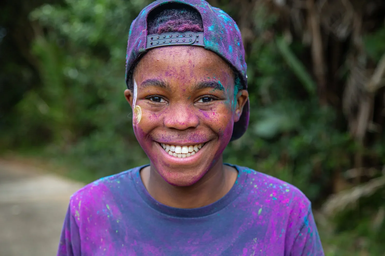 A smiling participant at the Zimbali Estate Colour Run.