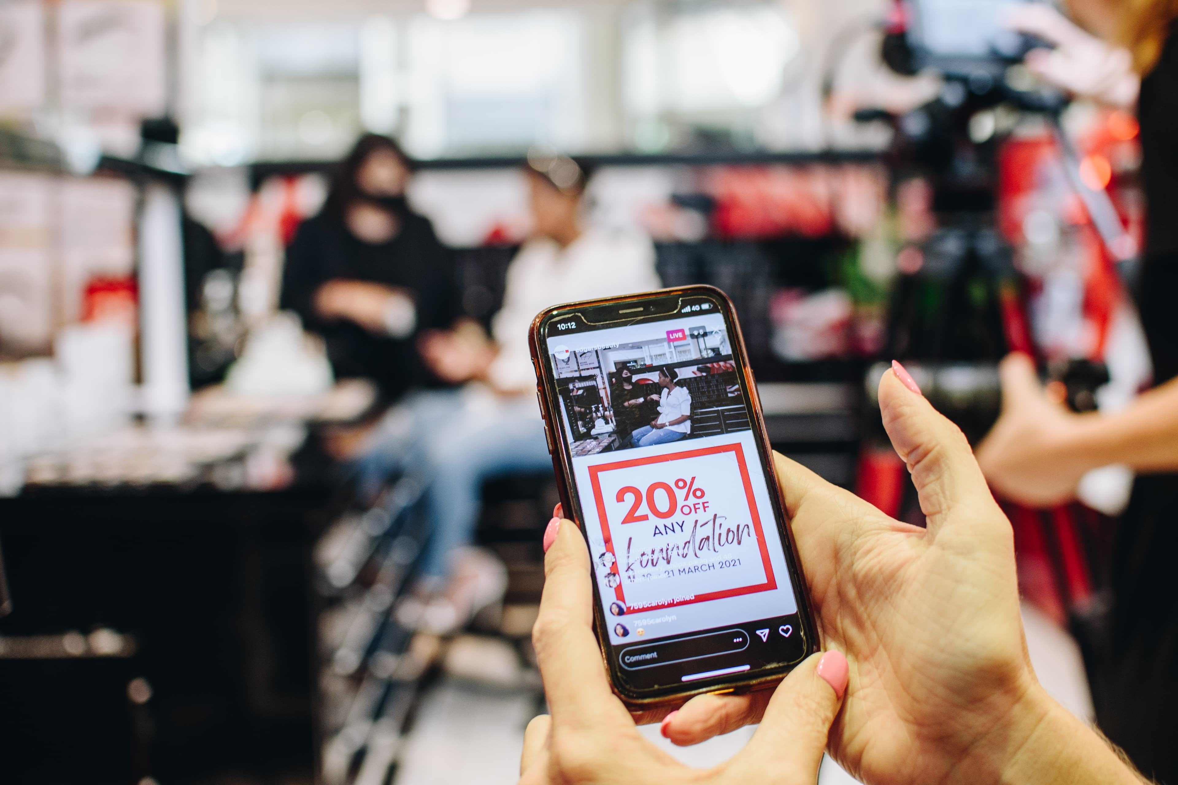 A live digital interaction displayed on a phone within an event environment.