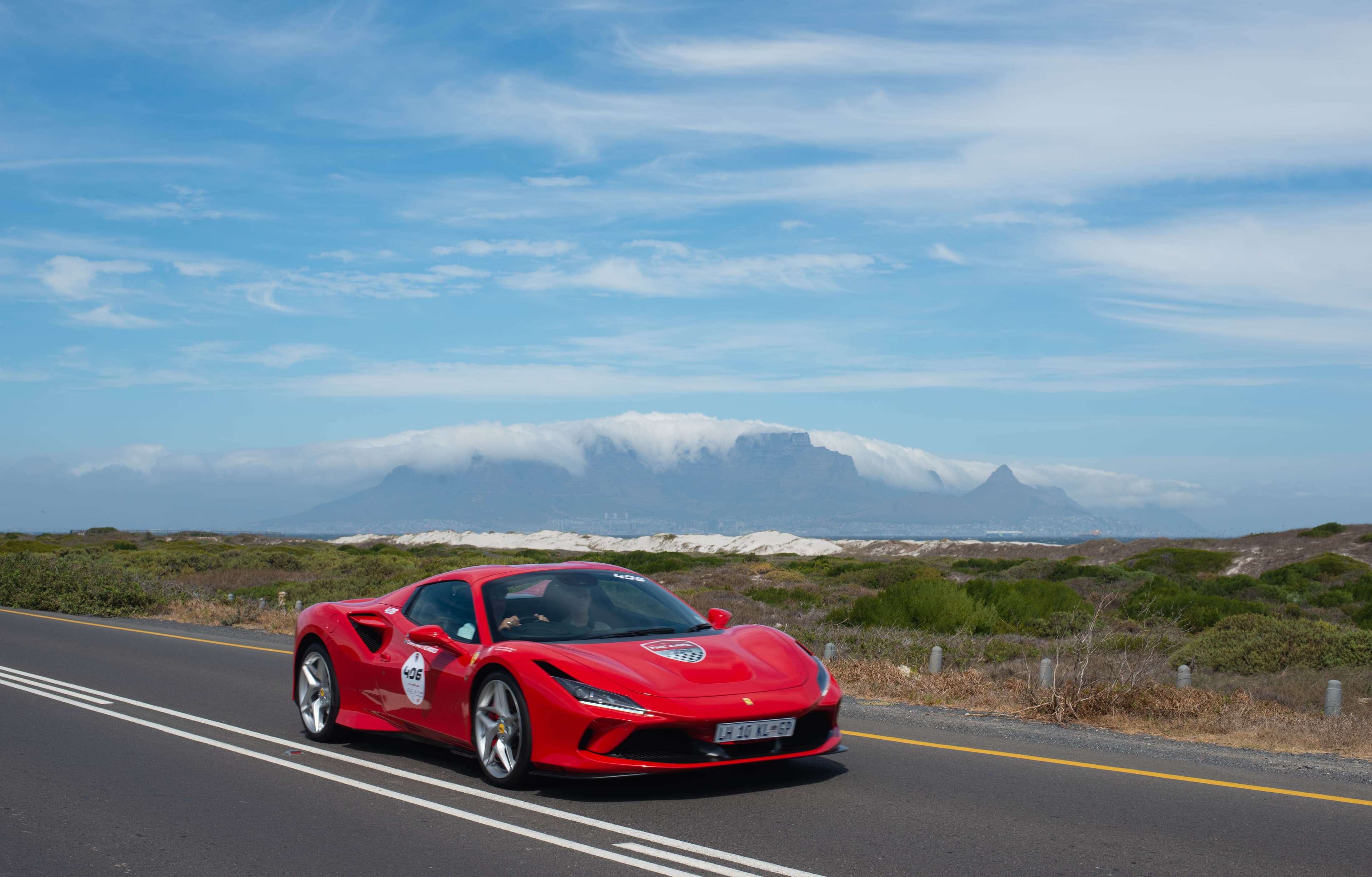 A Ferrari on The Cape 1000 2026 with Table Mountain beyond.